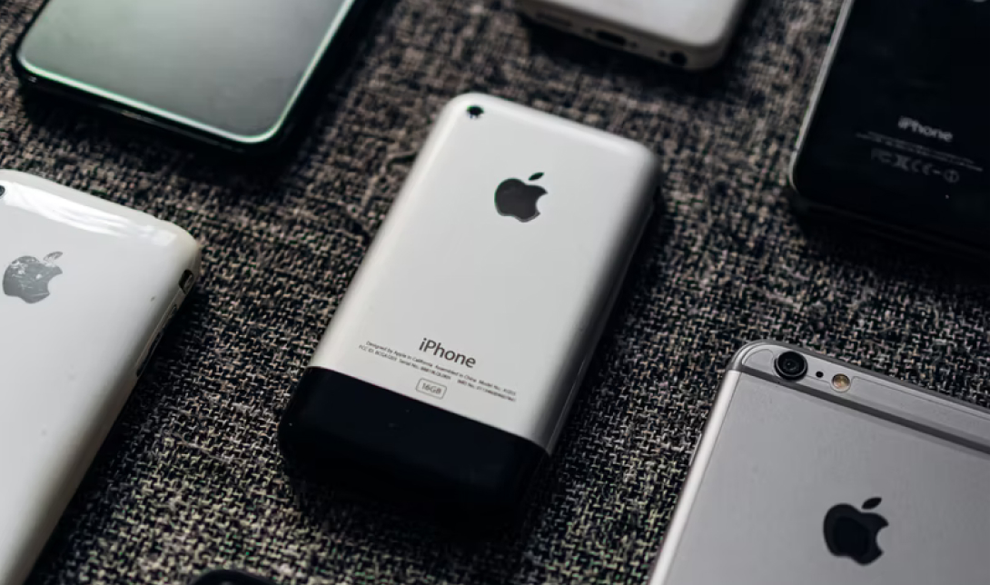 Old Generations Of iPhones Laying On A Table